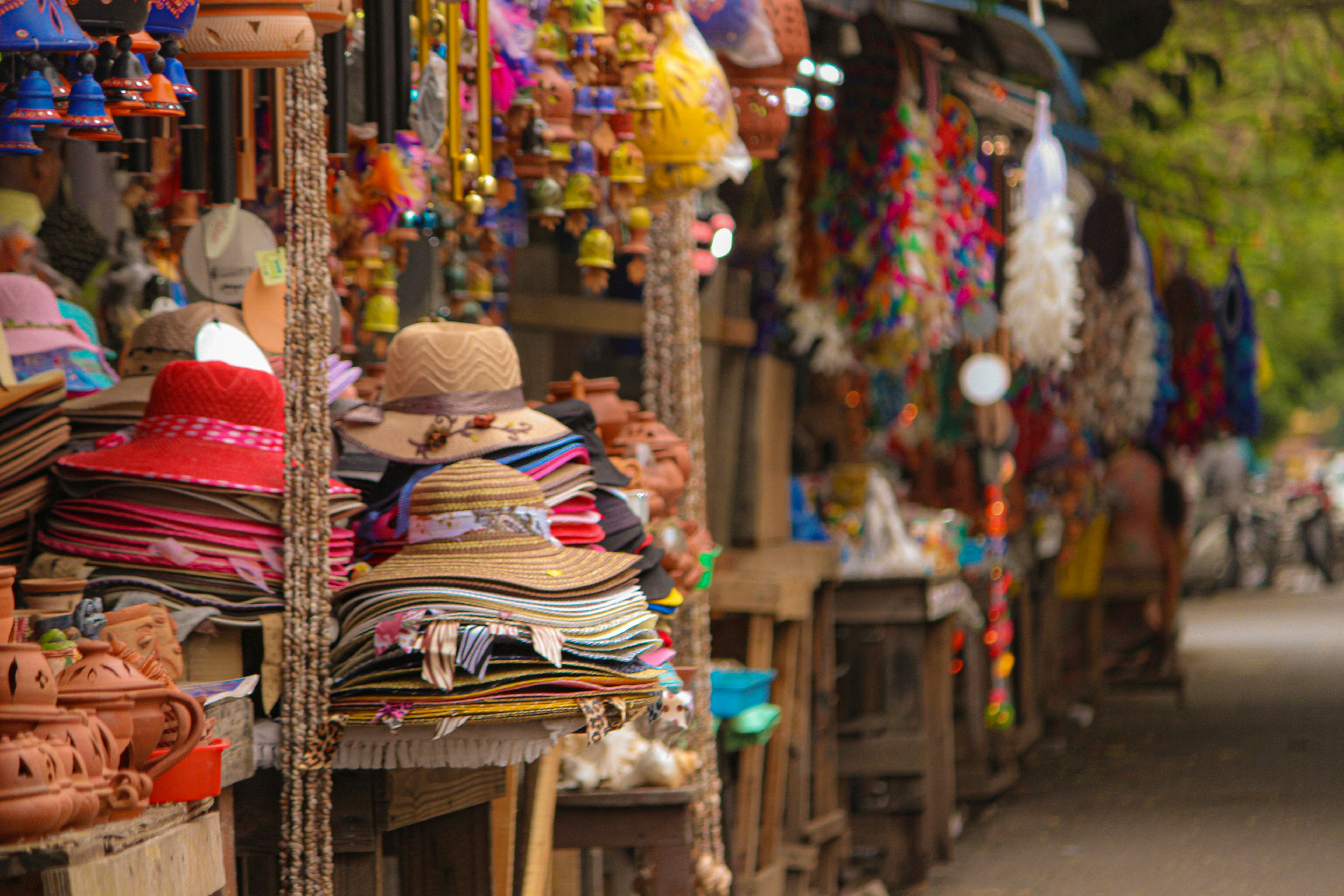 Handmade products by Indian makers — pottery, jewellery, candles, and block-printed textiles arranged on a wooden surface